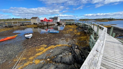 boardwalk and boats on a sunny day at Peggy's Cove in Nova Scotia