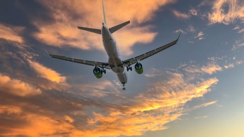 a large passenger jet flying through a cloudy blue sky