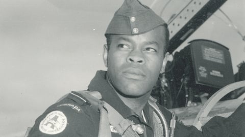 A photo from the 1960s shows Dr. Blizzard, a pilot standing beside a plane.