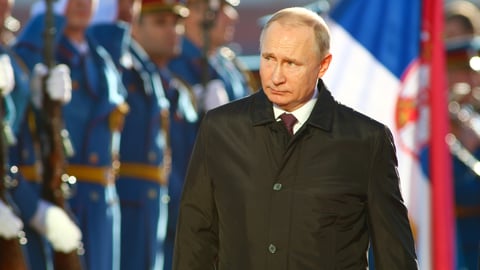 Vladimir Putin wearing a suit and tie