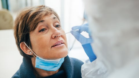 a person wearing glasses and smiling at the camera