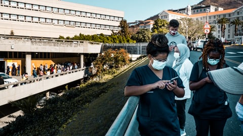 a group of people standing in front of a building