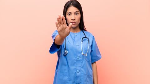 a person wearing a blue shirt talking on a cell phone