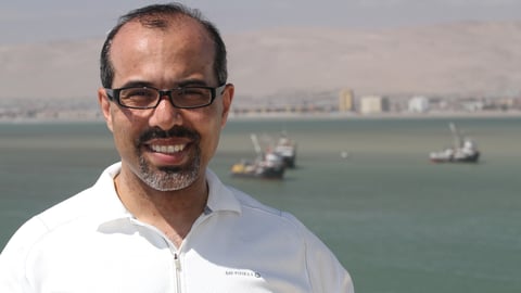 a man standing in front of a body of water