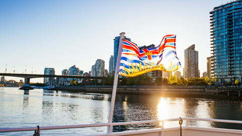 British Columbia flag flying in front of water