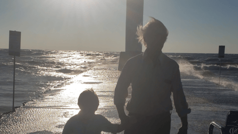 boy and dad holding hands on pier teaser