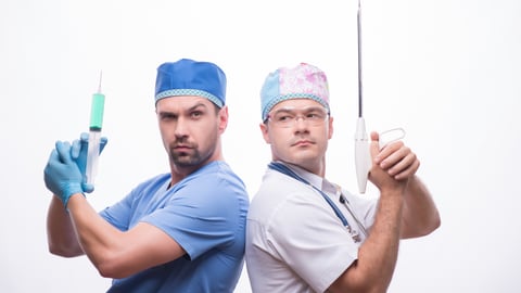 Two doctors back to back holding medical instruments as though they're guns