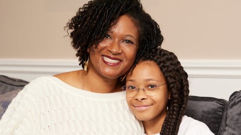 Mother and daughter smiling at camera 