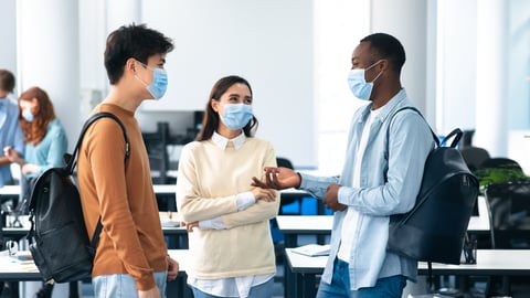 Group of students wearing masks and chatting