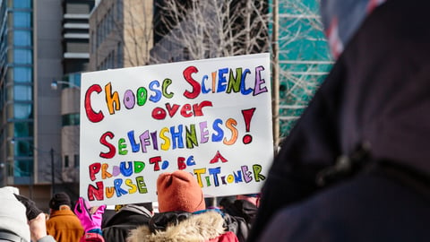 Counter protesters holding signs in support of healthcare workers