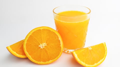 Oranges with a glass of orange juice