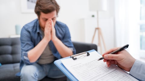 anxious looking young man at doctors office