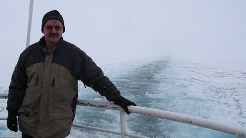 Man on back of boat.