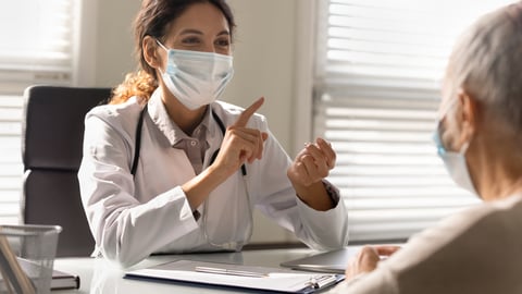 Happy doctor chatting with a patient