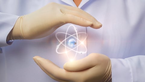 Doctor's hands holding a nuclear symbol