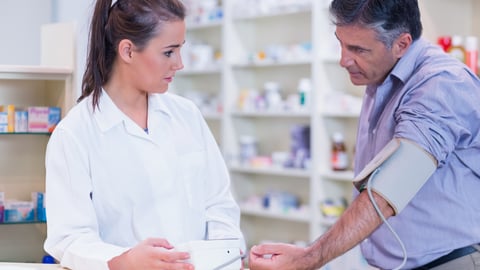 Pharmacist taking someone's blood pressure