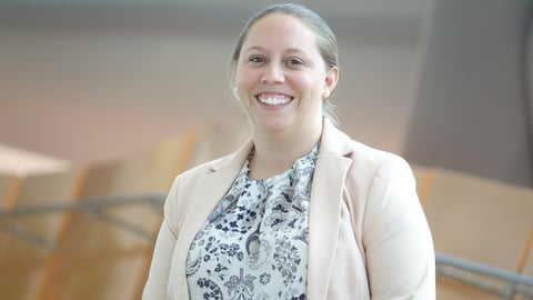 Dr. Leisha Hawker smiles while wearing a white sweater and a printed shirt. 