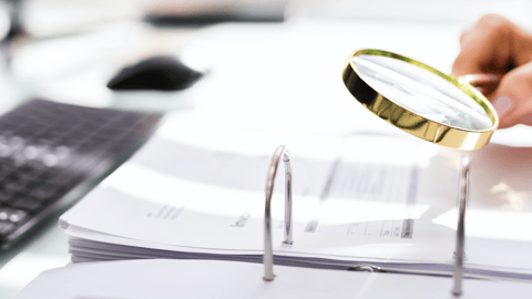 magnifying glass over documents