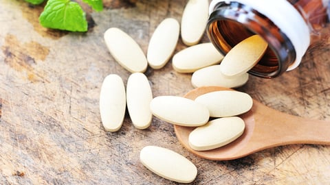 brown bottle with supplements spilling out