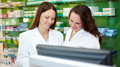 Two pharmacists looking at the computer together 