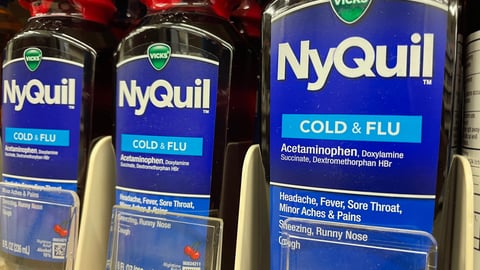 Bottle of cough syrup on a pharmacy shelf