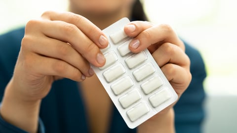 Woman taking out a pice of gum from a multi-pack