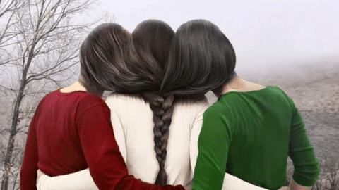 Three women with hair braided together