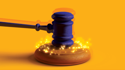 Gavel slamming down with a gold background