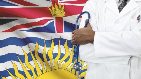 Doctor standing in front of the British Columbian flag