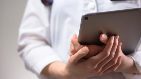 Healthcare worker holding tablet