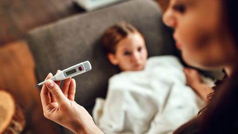 Mother checking child's temperature