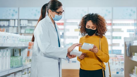 Pharmacist helping young patient