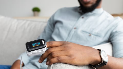 Black man wearing a pulse oximeter