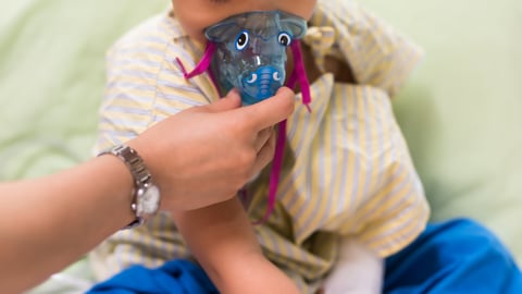 Child with a breathing aparatus