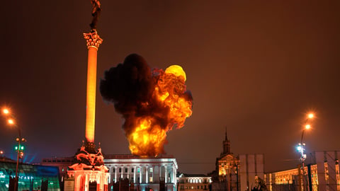 Square in Ukrainian city with an explosion in the background