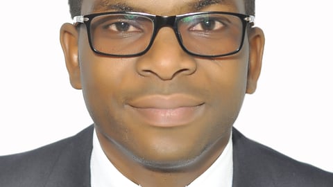 a man wearing glasses and a suit and tie