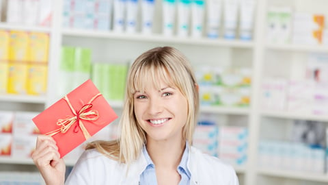 Pharmacist holding a red card