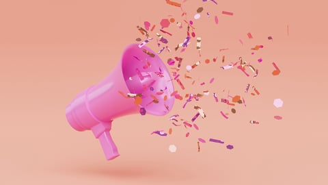 A pink megaphone with confetti flying out