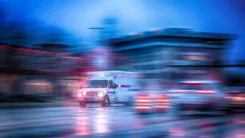 a blurry image of a street with an ambulance