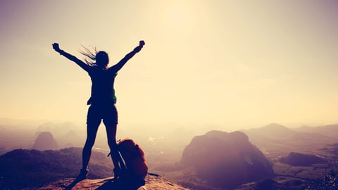 a woman  on top of a mountain