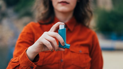 Woman holding an inhaler