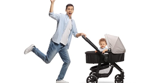 man-waving-running-with-baby-in-stroller