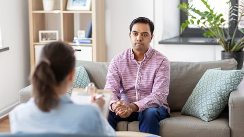 South Asian man sitting with a therapist