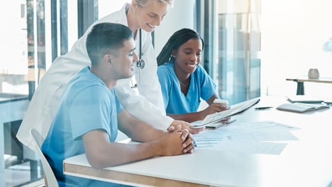 A group of diverse healthcare professionals laughing together