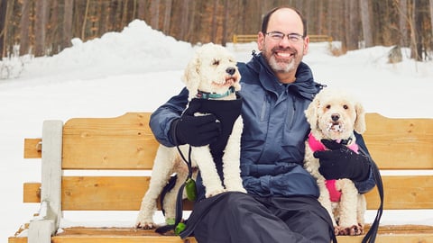 Man out in the snow with his dogs