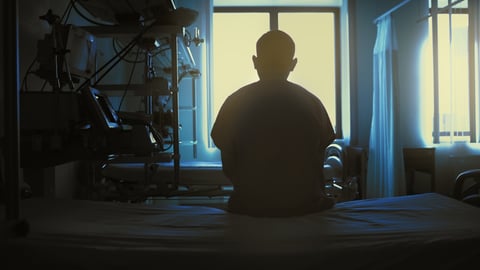 A patient sitting on a hospital bed