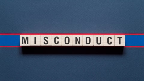 The word misconduct is spelled out in wooden blocks