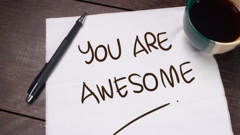 Piece of paper with words handwritten, "You are awesome," with coffee cup in the corner