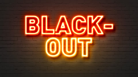 red-and-yellow-lit-up-sign-black-out