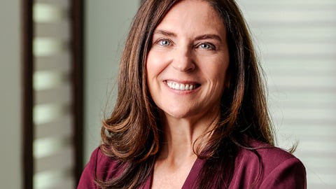 woman-dark-hair-suit-smiling